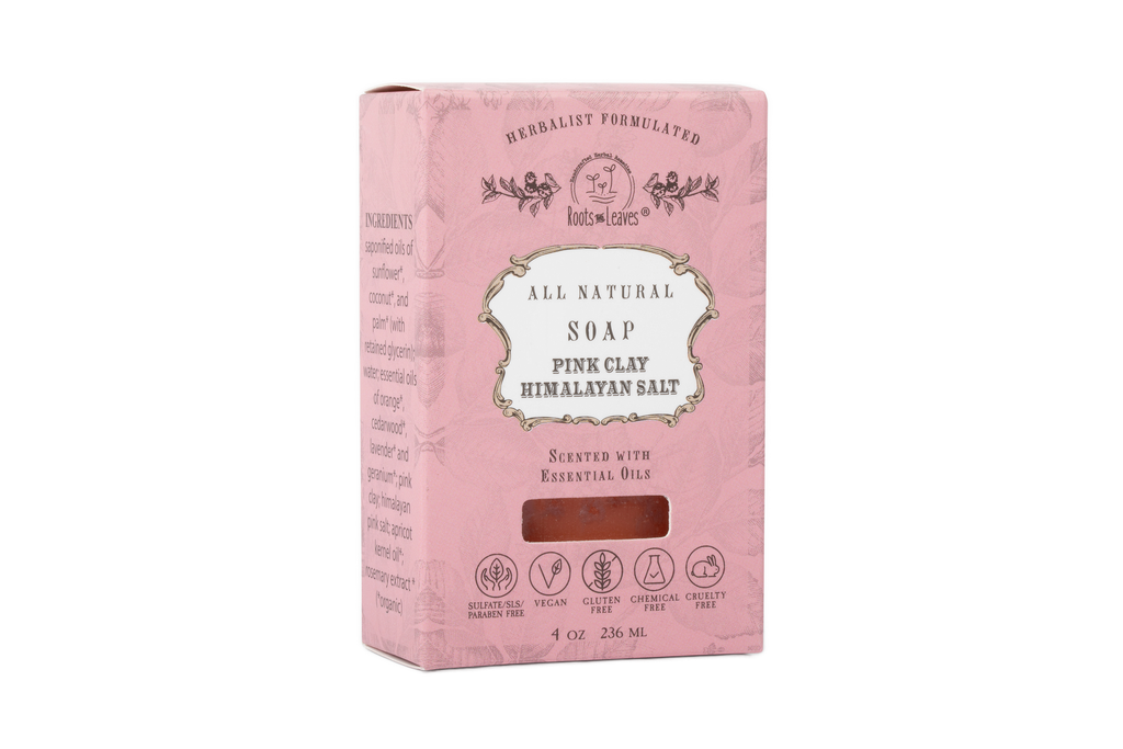 A pink rectangular box of Roots And Leaves Organic Vegan Pink Clay + Himalayan Salt Bar Soap, featuring vegan, cruelty-free, chemical-free, and palm oil free claims on the packaging.