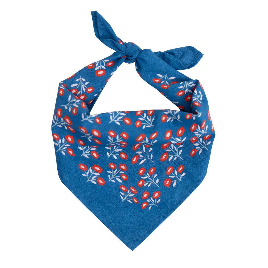 The No. 075 Juliet Bandana by Handker Bandanas is a premium blue cotton bandana featuring a white and red floral pattern, hand screen-printed, folded into a triangle, tied at the top, and measuring 22x22 inches on a plain white background.