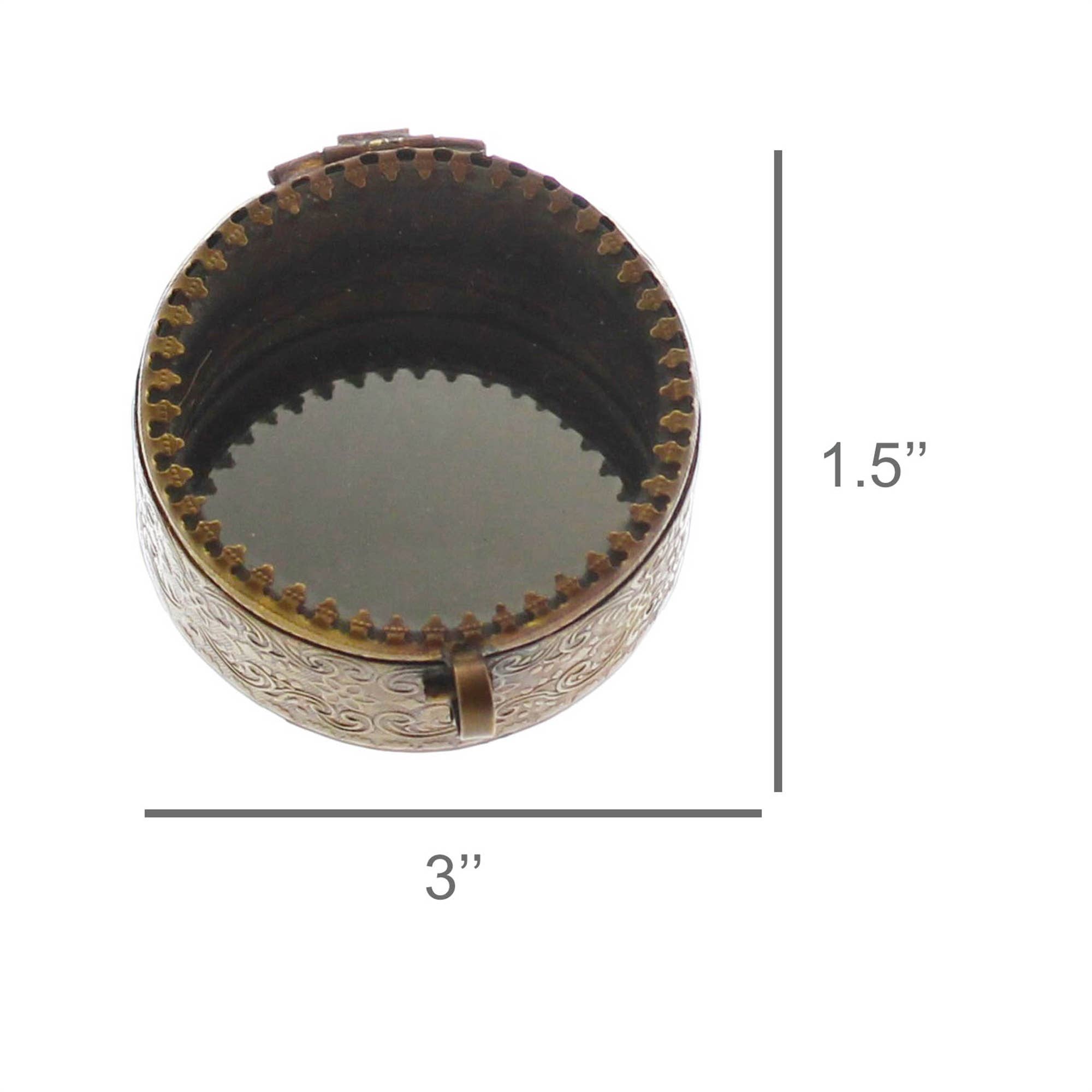 The HomArt Josephine Mirrored Box, Brass – Sm Round, features a round, ornate brass design with a hinged lid. It measures 3" in diameter and 1.5" tall, with decorative patterns and a mirrored interior for elegant jewelry storage.