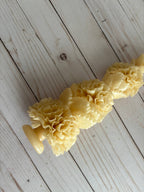 Ivory Large Floral Oaxaca Marigold Day of the Dead Candle handmade in an ivory color and molded into a stack of ruffled marigold flowers.