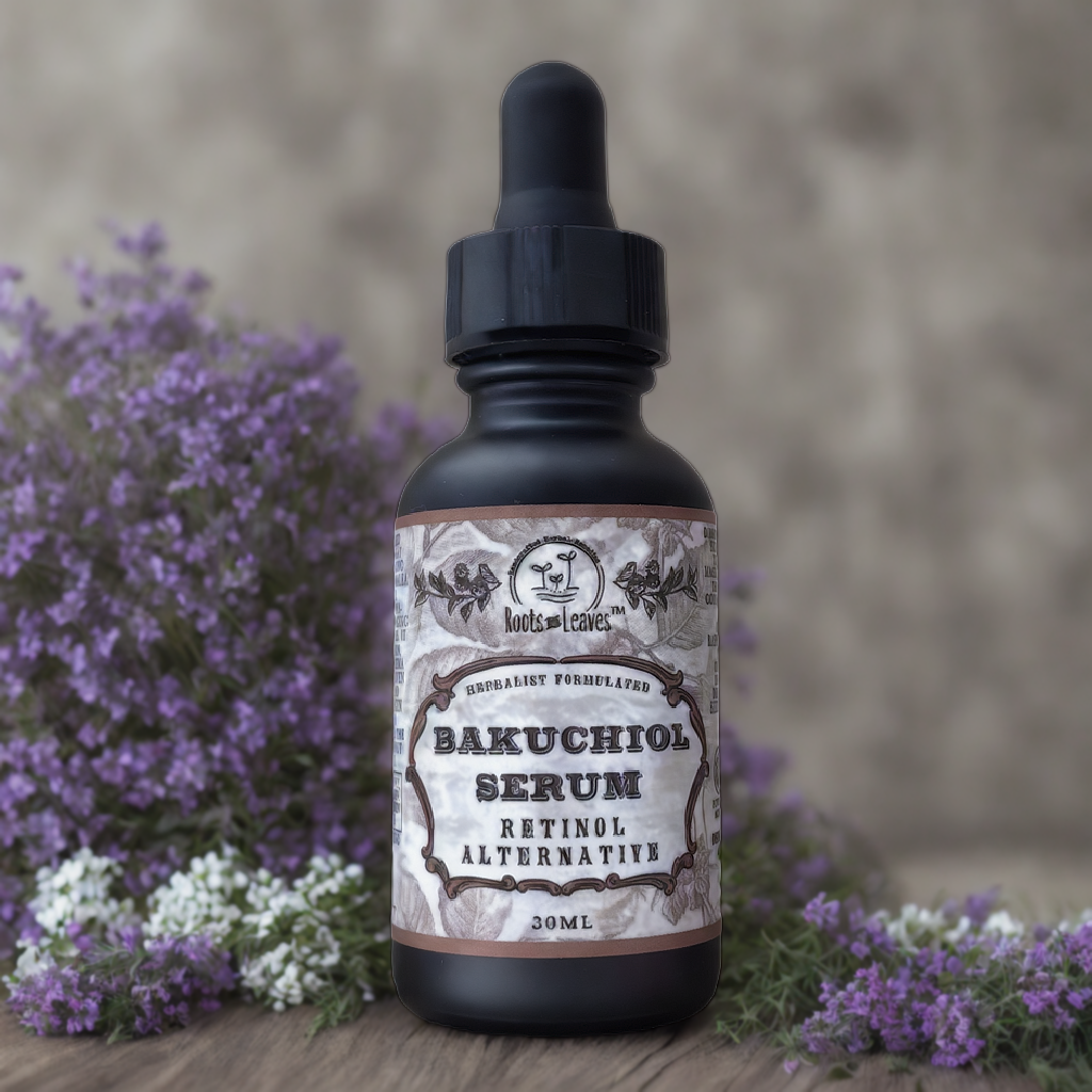 A bottle of Roots And Leaves Bakuchiol Serum - All Natural Retinol Alternative with a dropper sits on a surface covered in purple flowers, with more purple blooms blurred in the background. The label shows botanical illustrations and its anti-aging benefits.