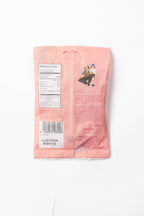 The back of the BonBon - A Swedish Candy Co Sour Wild Strawberry Fish 5.2oz (150g) vegan candy shows a pink package with nutrition facts, barcode, text, and two people sitting together. The expiration date is printed near the bottom.