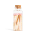The Pink Matches in Corked Vial by Enlighten the Occasion features several pink-tipped wooden matches neatly arranged in a small glass jar with a cork stopper, displayed against a white background.