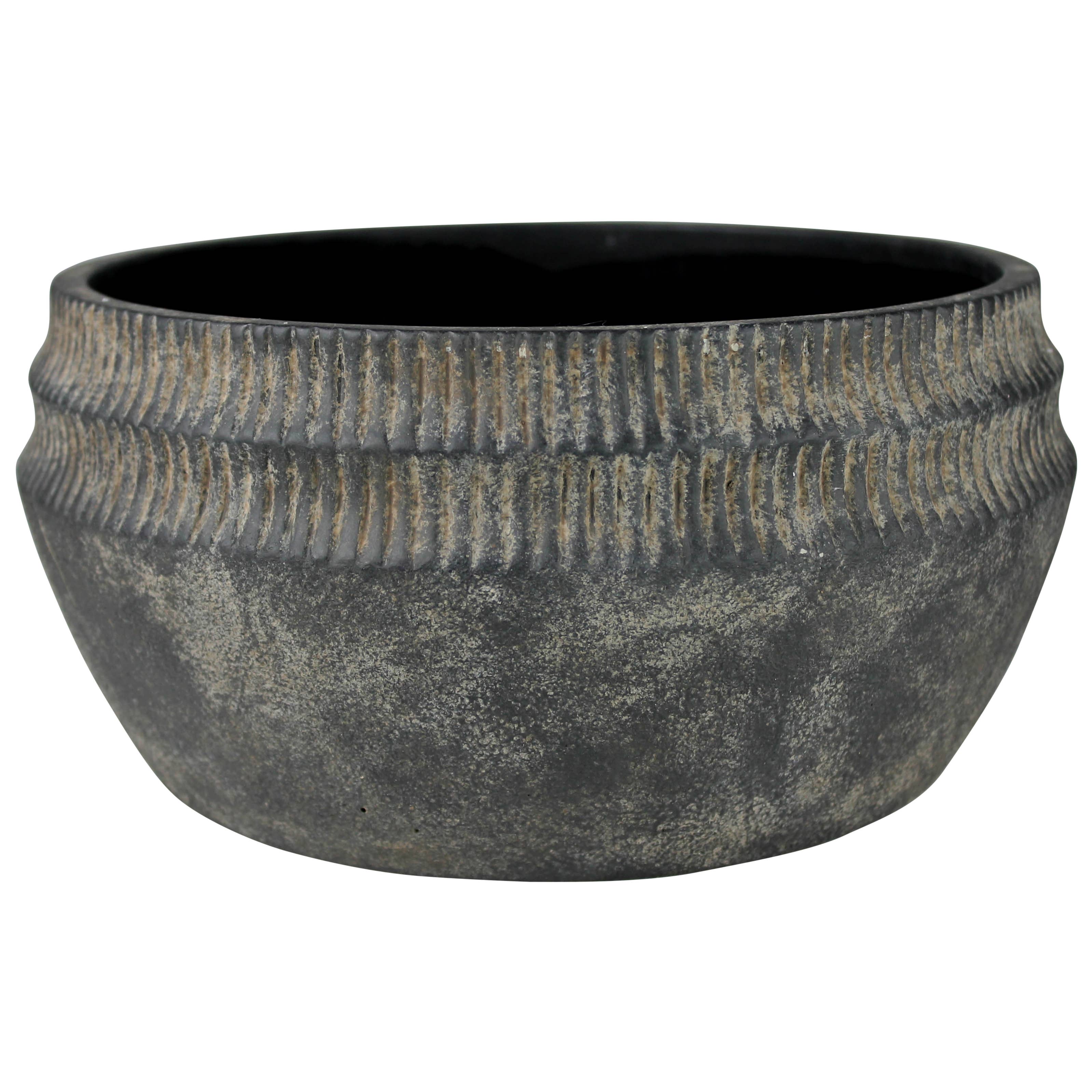 The HomArt Yara Low Planter, Cement - Lrg features a round, wide-mouthed design in dark gray cement with a ribbed upper exterior and matte finish—ideal for rustic garden decor.