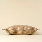 The Indaba Trading 16x24 Block Print Check Linen Pillow in brown features a soft, rectangular Belgian linen cover with a brown and beige checkerboard pattern, small fabric ties at each corner, and comes complete with filler.