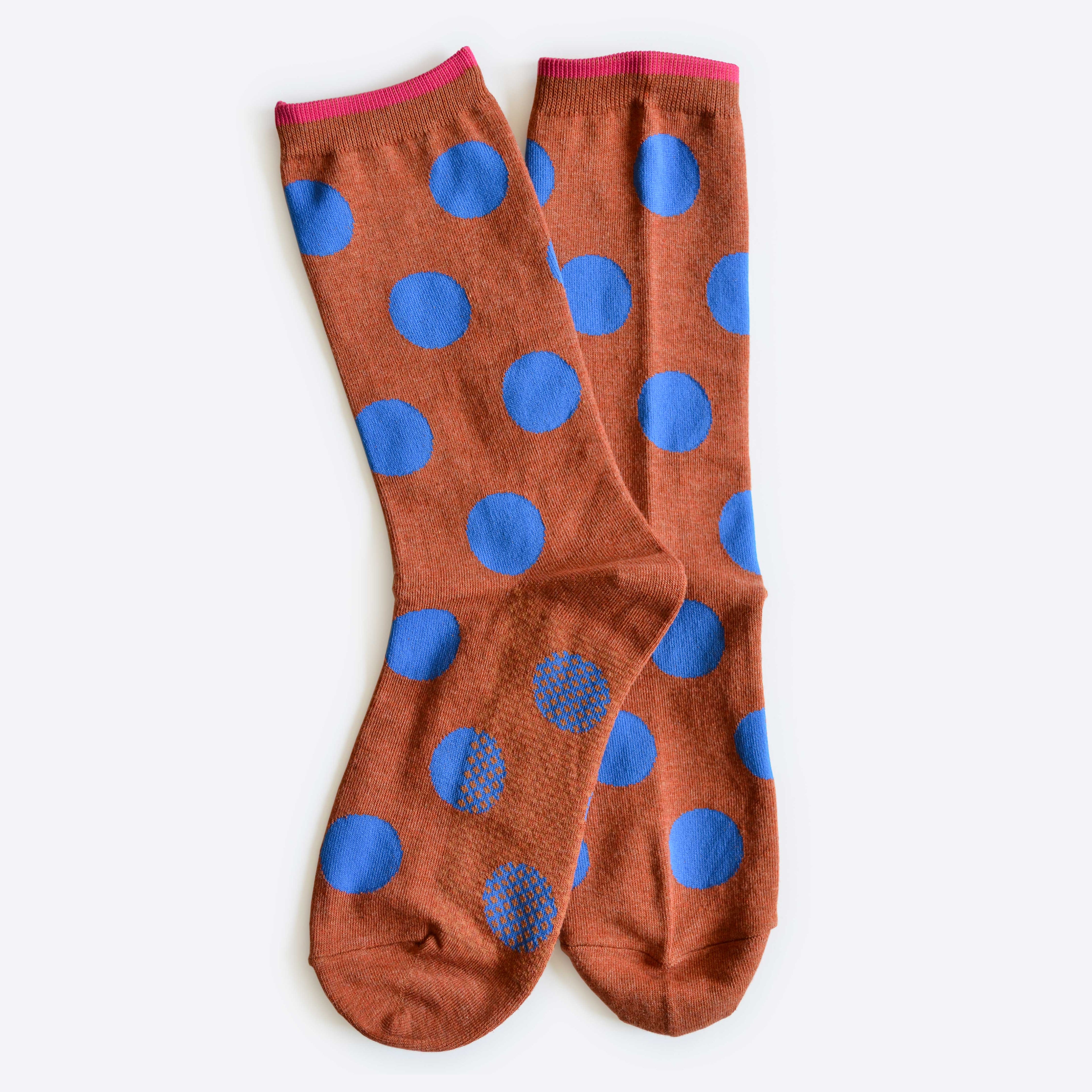 Panhandle Polka Dot Crew Socks by Hooray Sock Co. feature brown crew-length design with large blue polka dots and pink trim, crafted from a soft cotton-spandex blend for unisex, all-day comfort. Laid flat on a white background.
