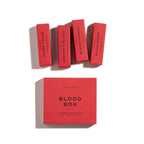 Four red perfume boxes labeled Blood Cedar, Dragon's Blood, Blood Orange, and Blood Berry are arranged above a larger red box labeled THE BLOOD BOX by Heretic Parfum—an immersive fragrance set of blood-inspired scents against a white background.
