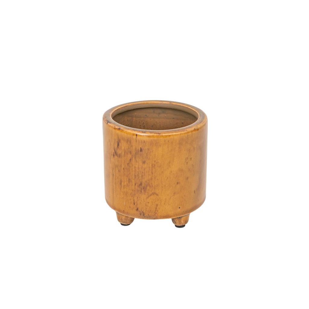 The Foreside Home & Garden Glossy Brown Ceramic Planter Pot features a small, round design with three short legs, a smooth finish, and a subtle brown reactive glaze, shown isolated on a white background.