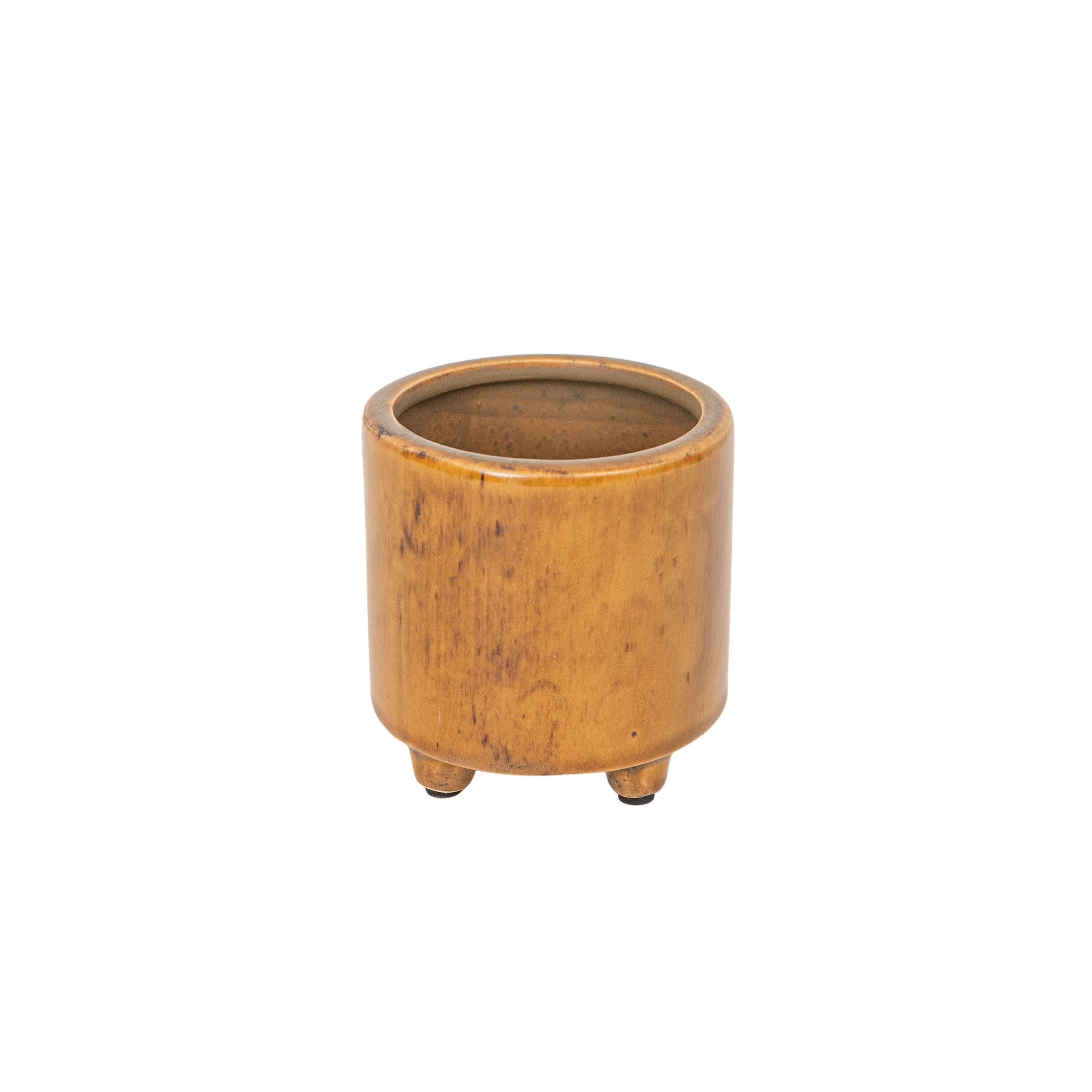 The Foreside Home & Garden Glossy Brown Ceramic Planter Pot features a small, round design with three short legs, a smooth finish, and a subtle brown reactive glaze, shown isolated on a white background.