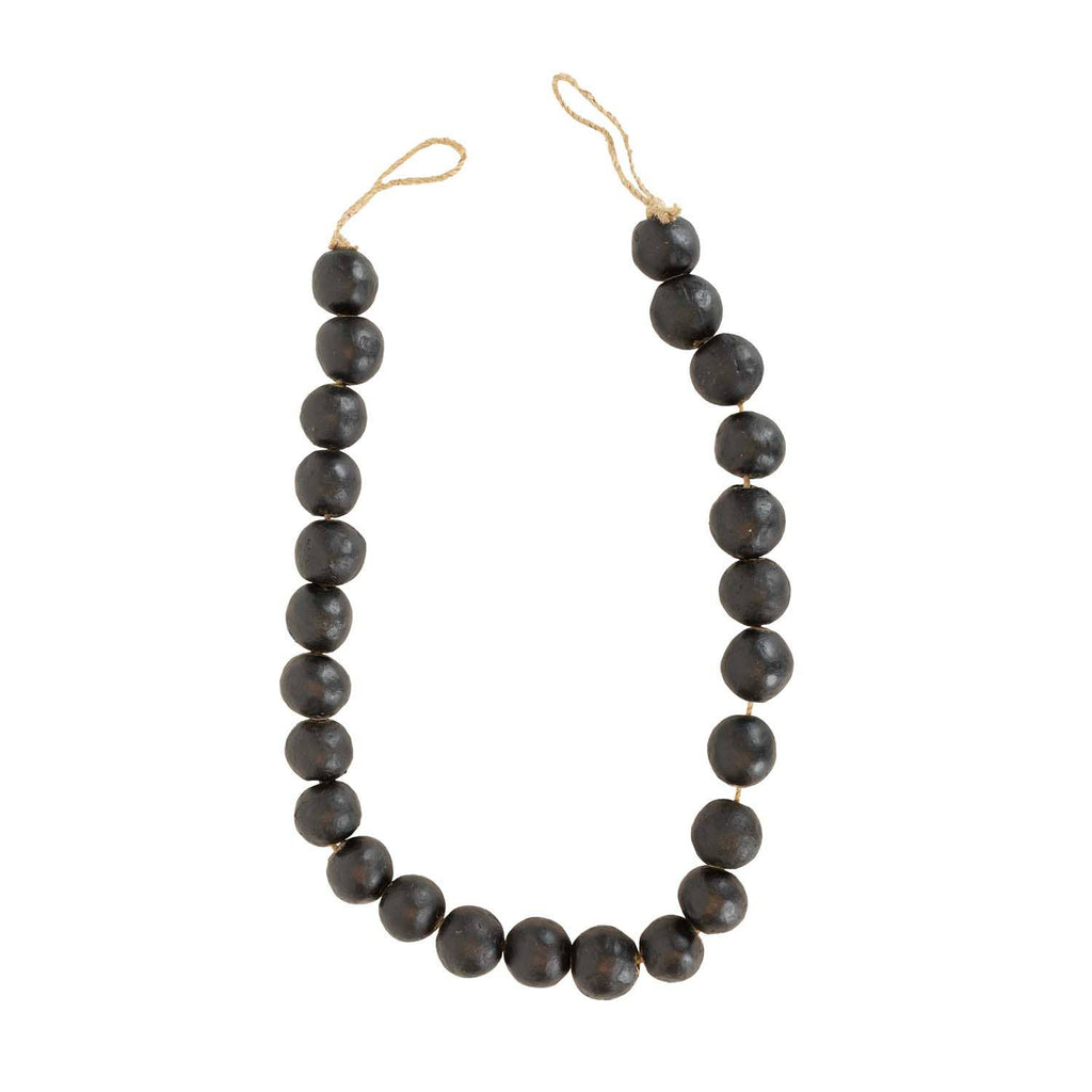 The Foreside Home & Garden Black Terracotta Bead + Jute Garland features large, round black terracotta beads and natural jute rope—offering a handmade Indian-inspired decor accent for your space.