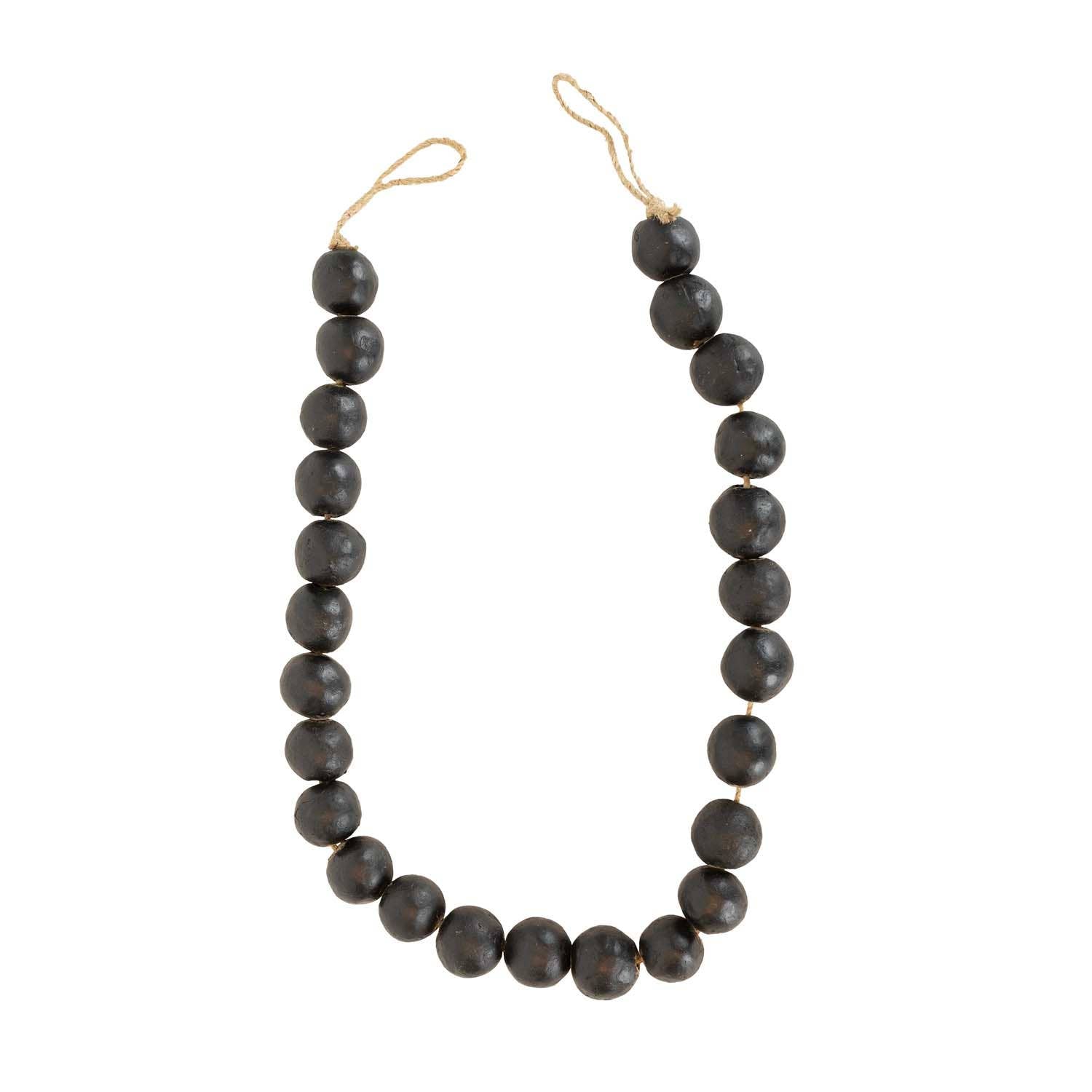 The Foreside Home & Garden Black Terracotta Bead + Jute Garland features large, round black terracotta beads and natural jute rope—offering a handmade Indian-inspired decor accent for your space.