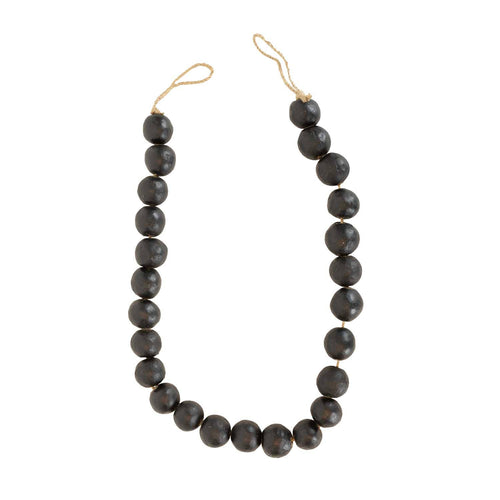 The Foreside Home & Garden Black Terracotta Bead + Jute Garland features large, round black terracotta beads and natural jute rope—offering a handmade Indian-inspired decor accent for your space.