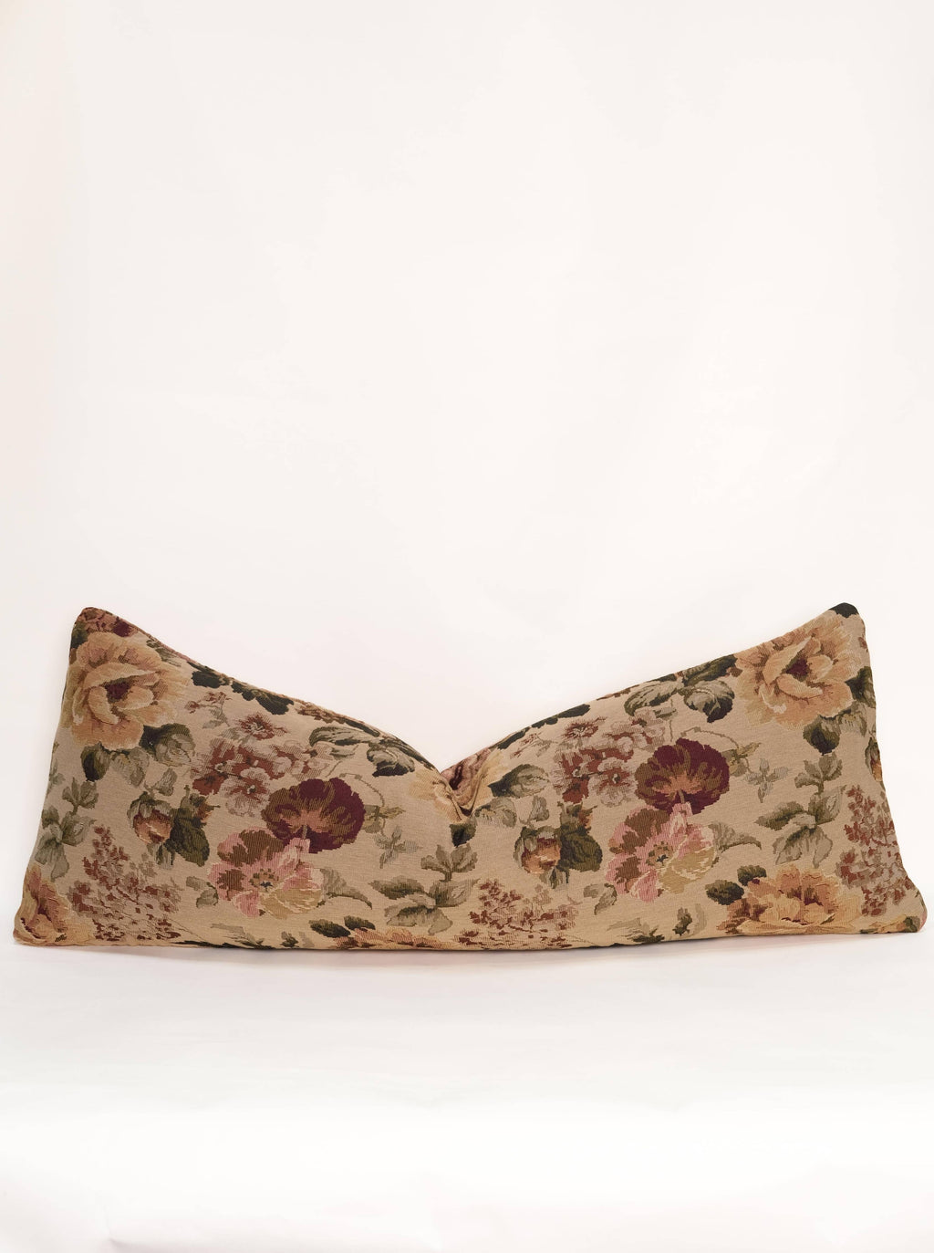 The Tapestry Long Lumbar by Twenty Third by Deanne is a long, rectangular jacquard pillow featuring a floral tapestry pattern in brown, green, and burgundy on a plain white background.