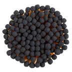 Enlighten the Occasion’s Black Matches in Corked Vial are arranged closely together in a circular pattern, resembling black wooden matches grouped from above on a white background.