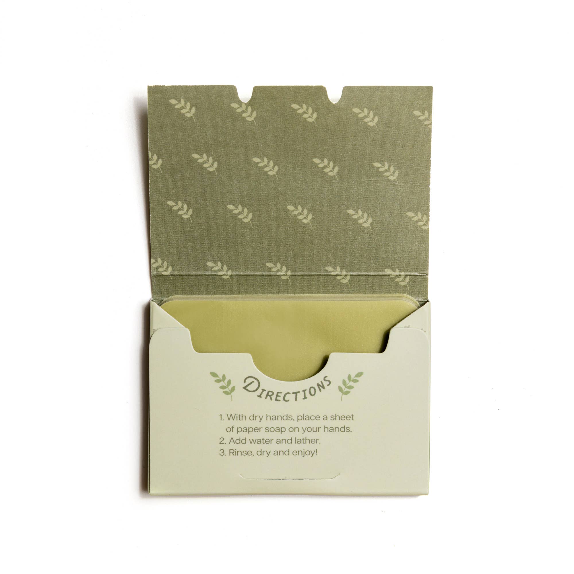 An open 123 Farm Paper Soap – Olive Oil, Travel Size (50 Sheets) pack reveals thin soap sheets. Inside the lid are leaf patterns; front instructions say: add water, lather, rinse, dry—perfect portable hand washing!.