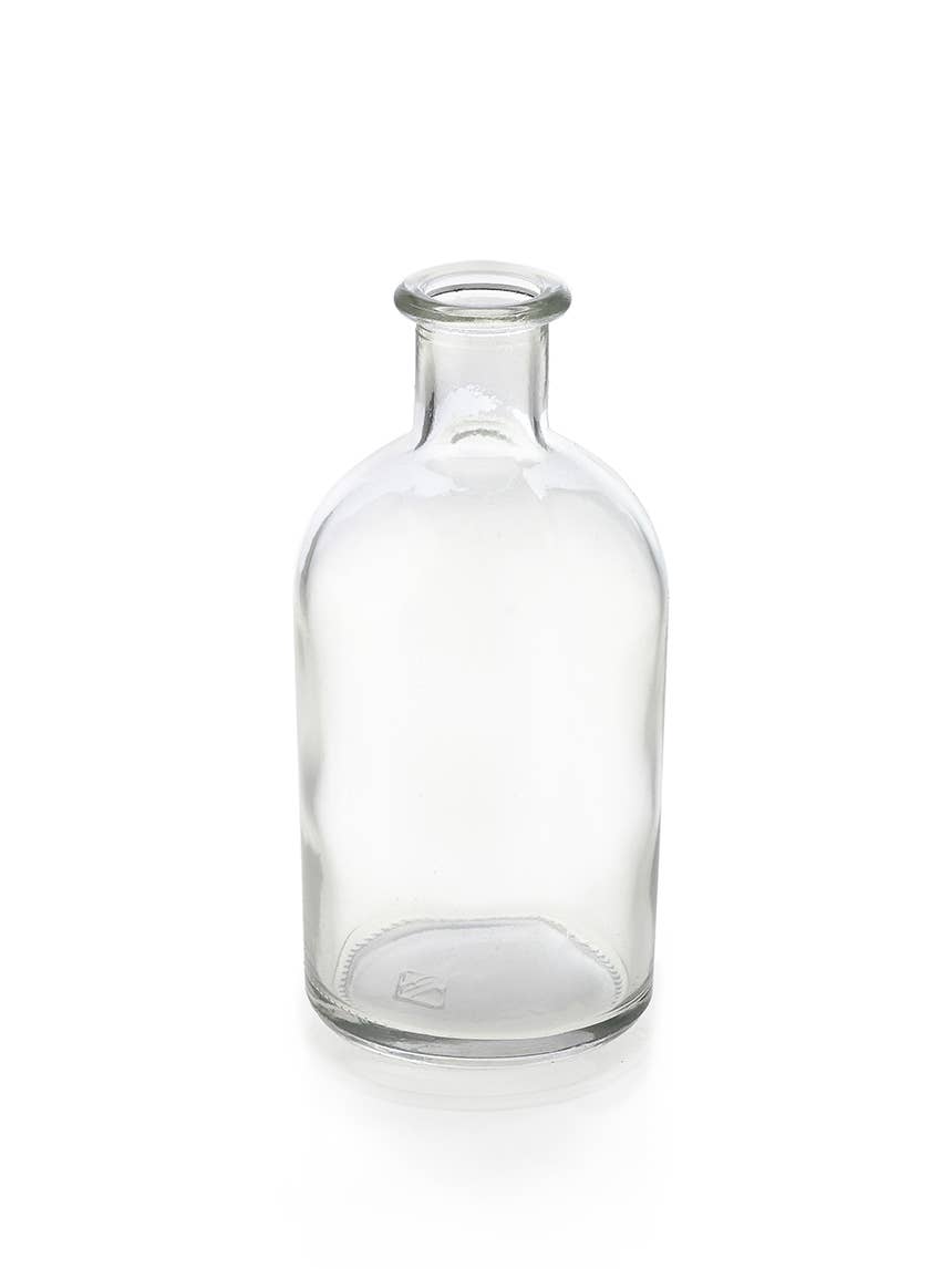 The Jamali Garden Clear Medicine Bottle Bud Vase features a short neck and wide mouth, standing upright on a white background—ideal as a unique flower vase or stylish accent for your home decor.