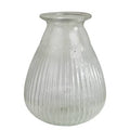 The HomArt Peppered Vase features a wide bottom and narrow, flared opening. Crafted from seeded glass with elegant vertical grooves, its ribbed design offers a simple yet sophisticated touch to any décor.