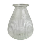 The HomArt Peppered Vase features a wide bottom and narrow, flared opening. Crafted from seeded glass with elegant vertical grooves, its ribbed design offers a simple yet sophisticated touch to any décor.