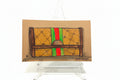 Rachel Nelson • Guch by Thyne Goods: Brooklyn artist’s drawing of a brown designer clutch with green-red stripe and “GG” logos on a clear easel. Bold neon flower style pops against a white background.