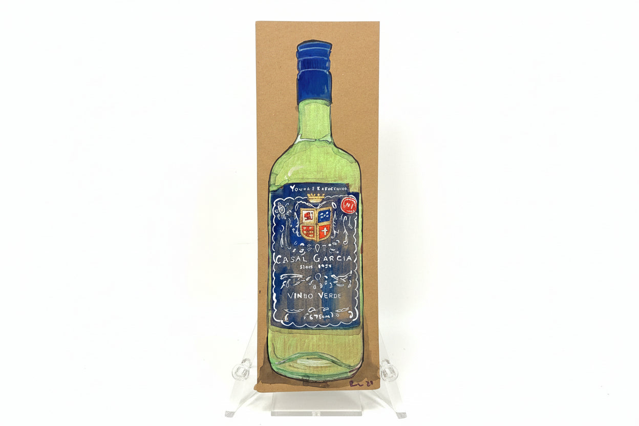 A hand-drawn green wine bottle with a blue label is shown upright on brown cardboard. "Rachel Nelson • Young + Refreshing" by Thyne Goods stands on a clear easel against a plain white background.