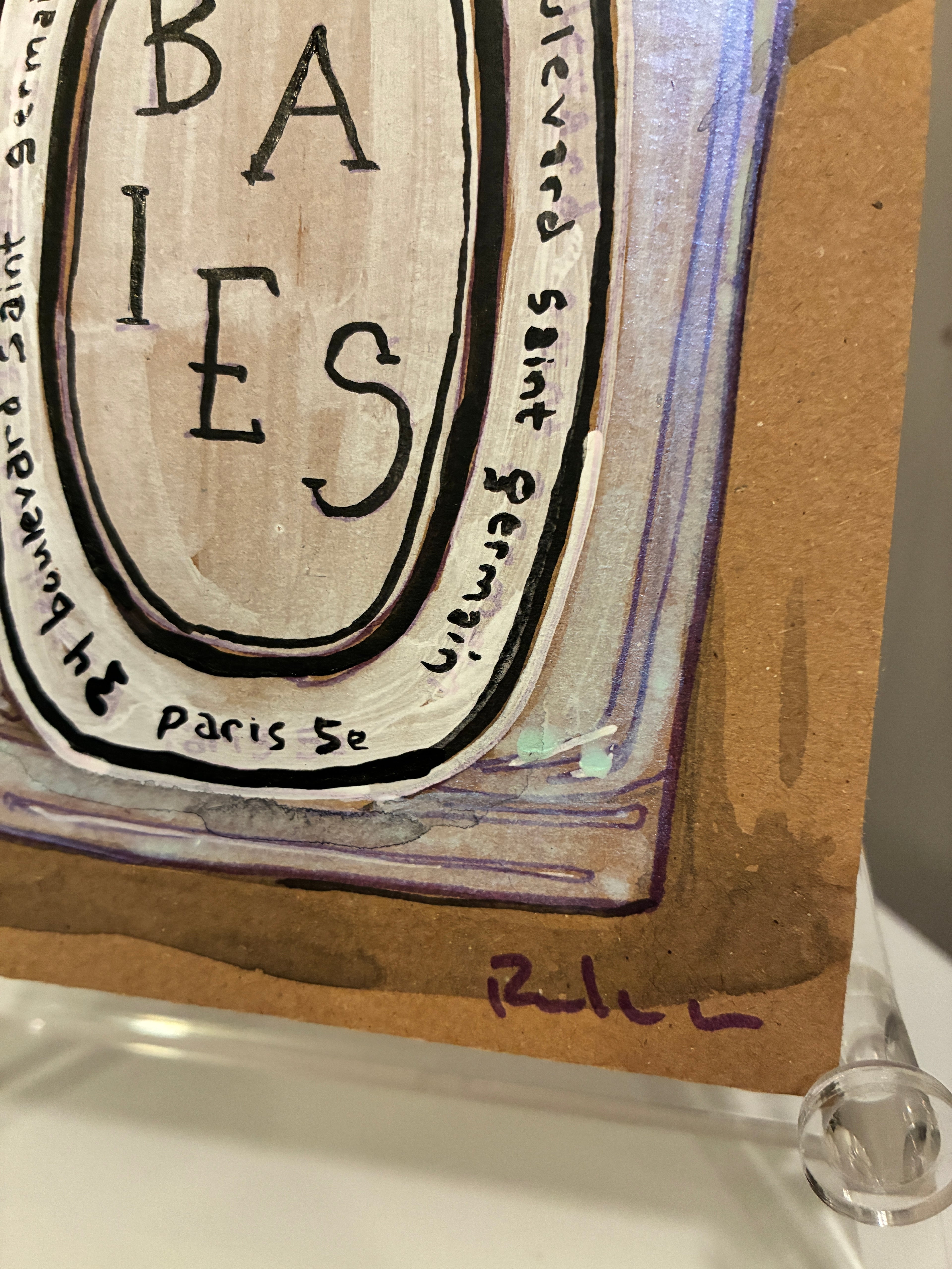 A close-up of Rachel Nelson's "Baies Paris" for Thyne Goods: a cardboard artwork with BABIES in bold, surrounded by "boulevard saint germain, paris 5e," and the artist’s purple signature at bottom right.