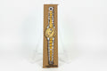 A hand-drawn illustration titled "Rachel Nelson • Watch" by Thyne Goods features a gold and silver wristwatch on brown paper, set upright on a clear easel against a white background, reflecting Rachel Nelson's refined style.