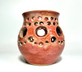 A ceramic vase named “Spam” by Thyne Goods, crafted from clay with a glossy red finish and featuring multiple round holes of varying sizes across its body, is displayed against a plain white background.