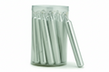 The SPIRIT LIGHT CANDLES: BALANCE (SILVER) by Benjamin International come in a clear container holding several silver cylindrical ritual candles, one leaning against the container. The candles feature rounded tops and pointed ends.