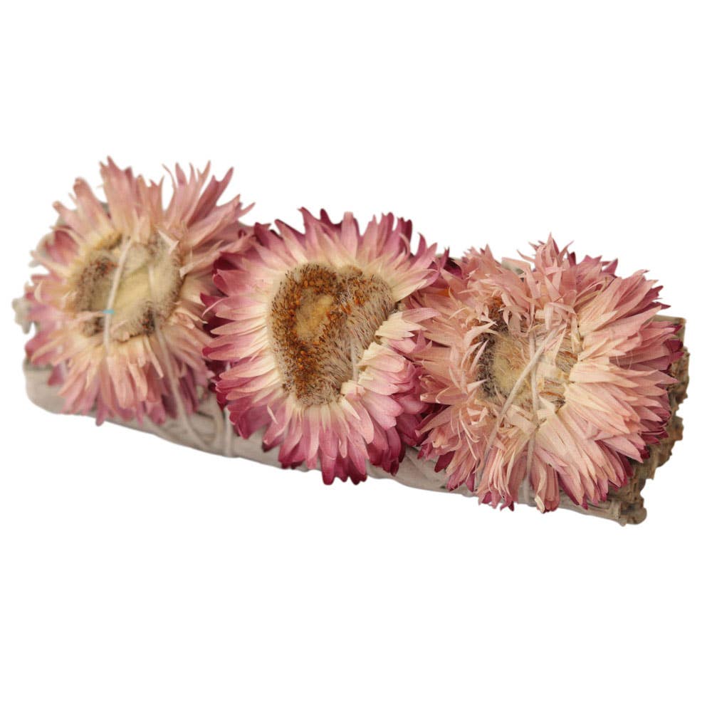 The Benjamin International WHITE SAGE/FLOWERS - HEALING bundle features white sage wrapped with three pink strawflowers and tied with string—an ideal addition to healing rituals. Photographed on a white background.