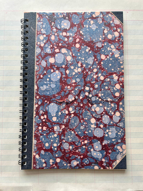 The Parcel Antique Endpaper Notebook: Large - Blue & Burgundy / Unlined features a marbled blue and burgundy cover, black spine and corners, and durable 110 cardstock—perfect for lasting use.