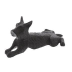 The HomArt Terrier Door Wedge is an antique brown cast iron sculpture, shaped like a dog lying down with front legs extended and head slightly raised.