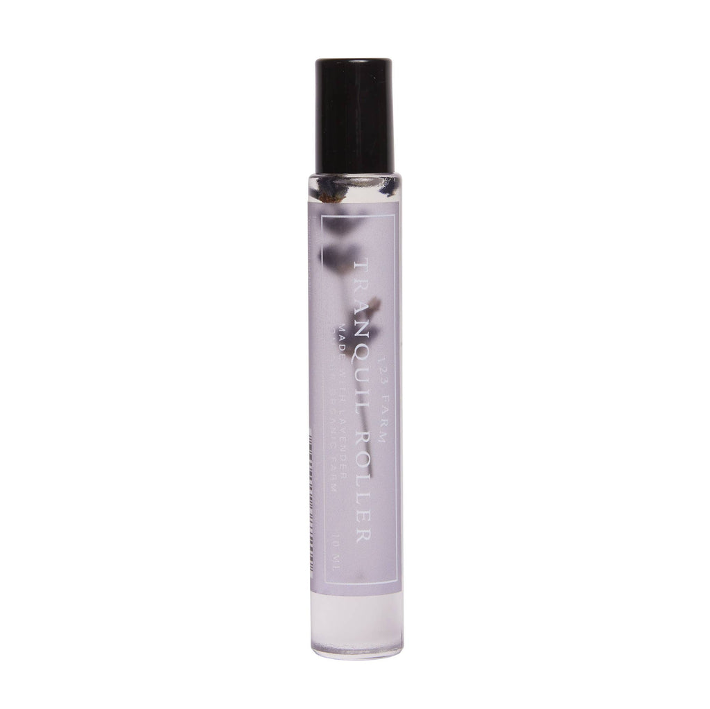 The 123 Farm Lavender Tranquil Roller – Organic Blend for Relaxation 10ml is a clear, portable bottle with light purple liquid and dark stones, perfect for on-the-go aromatherapy and organic relaxation.