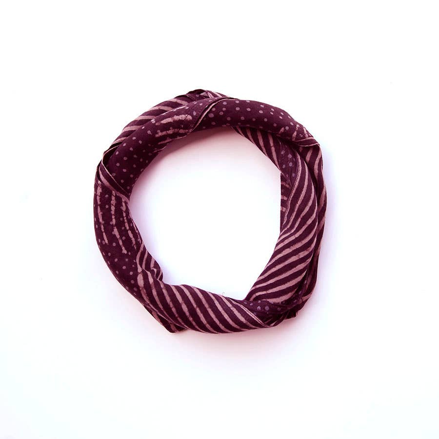 The Ichcha Square Bandana Scarf Artisan Block Print Ladies in violet features a mix of striped and dotted patterns, neatly arranged in a square shape on a plain white background.