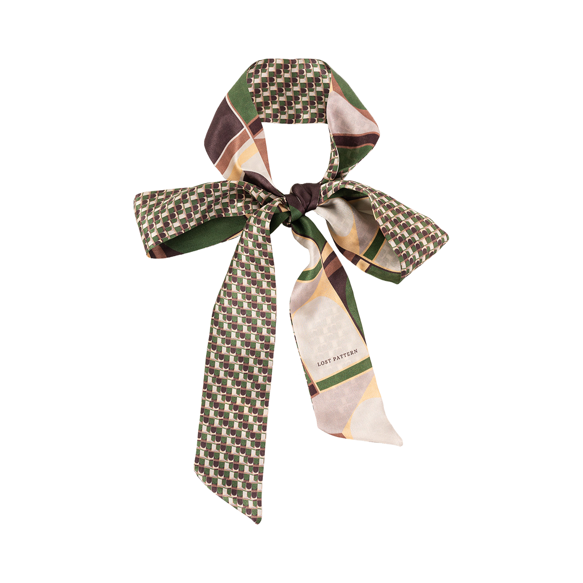 The Silk Skinny Scarf - Green by Lost Pattern NYC features a geometric pattern in green, brown, cream, and yellow. Made of silk satin with double-sided stitching and LOST PATTERN branding—ideal as a chic hair accessory tied in a bow.