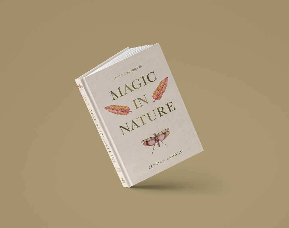 A Practical Guide to Magic in Nature by Jessica Lahoud, a 256-page hardcover from Simon & Schuster, stands upright on a light brown background—an enchanting English guide to the magic and correspondences found in nature.