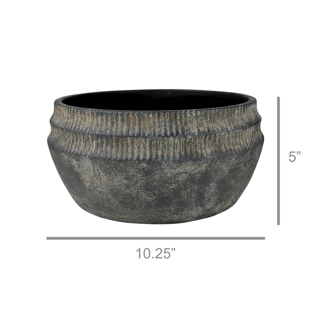 The Yara Low Planter by HomArt is a large, round, dark gray cement bowl with a ribbed top. At 5" tall and 10.25" wide, this rustic planter adds stylish garden decor to any space. Measurement lines show its exact dimensions.