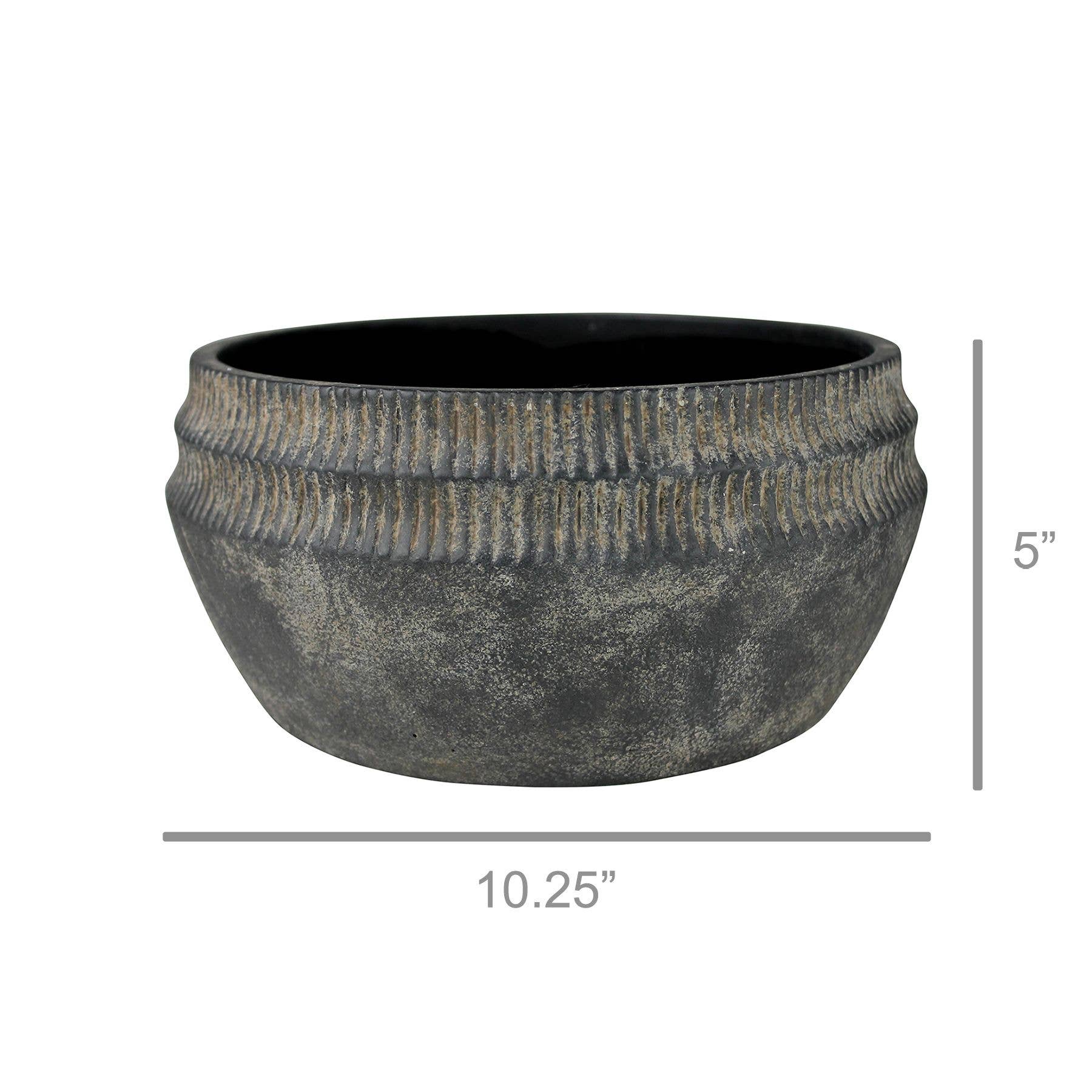 The Yara Low Planter by HomArt is a large, round, dark gray cement bowl with a ribbed top. At 5" tall and 10.25" wide, this rustic planter adds stylish garden decor to any space. Measurement lines show its exact dimensions.