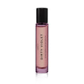 A purple glass perfume bottle with a black cap, labeled "Heretic Parfum DIRTY VIOLET: 15ML" vertically on the front, is photographed against a white background and features notes of violet leaf and amber.