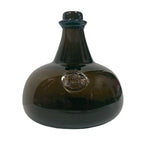 The Madison Bay Co. Hand-Blown Dark Green 76-oz. Onion Bottle (8") features a wide base, narrow neck, short top, and an embossed front medallion. This historical reproduction is shown on a plain white background.