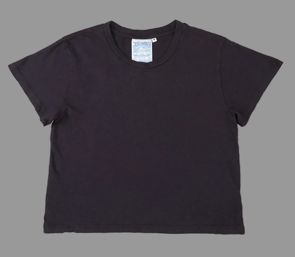 Black t-shirt with a brand label on a white background
