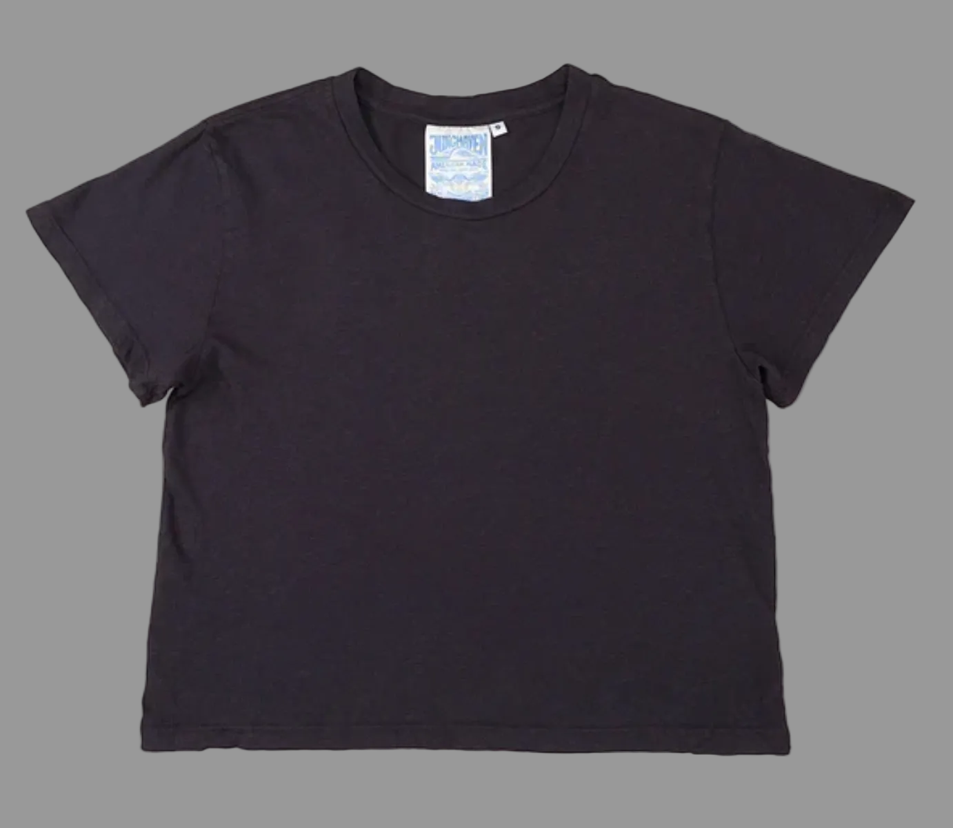 Black t-shirt with a brand label on a white background