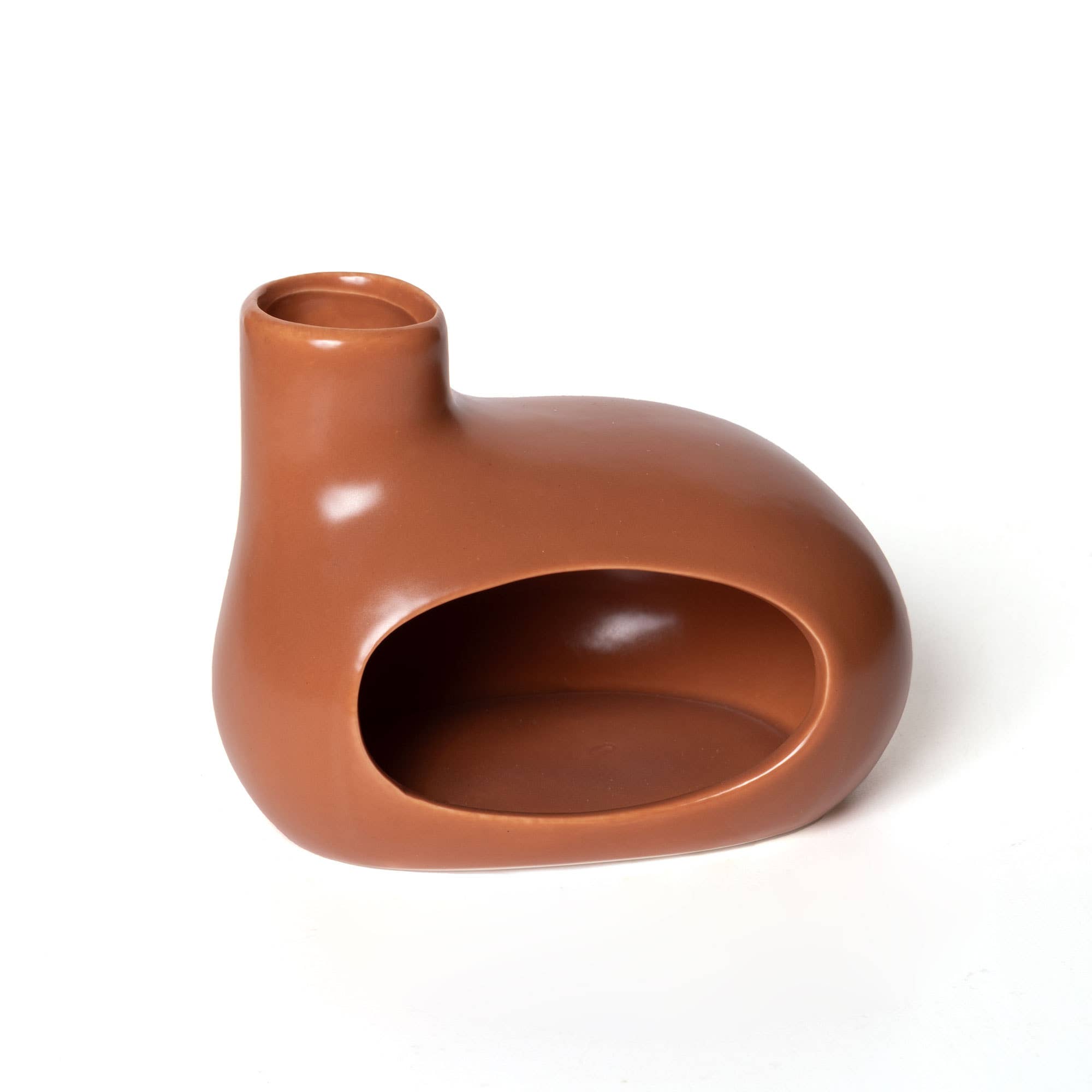 The 123 Farm Ceramic Incense Burner Oven features a modern, smooth brown ceramic design with an asymmetric shape, small round top opening, and large oval front cutout—ideal as a meditation centerpiece or elegant smudge stick holder.