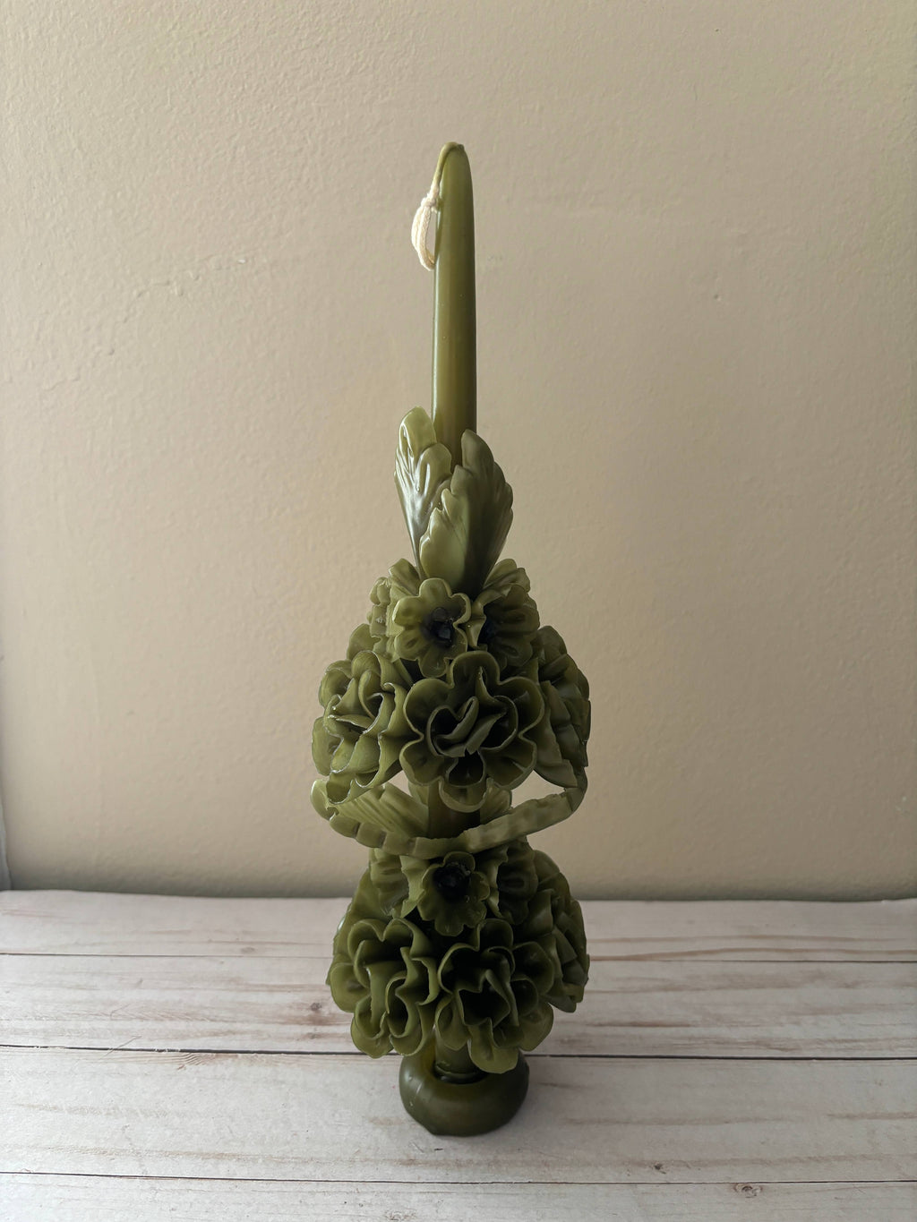 Olive Green Large Oaxaca Marigold Candle, a handmade olive green taper candle sculpted with two tiers of layered flower blossoms in the style of an Oaxaca candle.