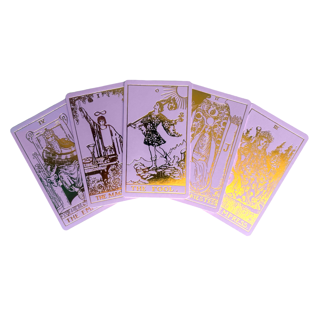 Five cards from the Lavender Gold Foil Tarot & Guide | Classic Tarot Design by Vieux Monde are fanned out, displaying The Emperor, The Magician, The Fool, The High Priestess, and The Empress.