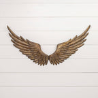 The ANTIQUE REPRODUCTION GOLD WALL WINGS by Ragon House feature a rustic golden-bronze finish and hang symmetrically on a white shiplap wall with sturdy keyhole hangers, creating striking decorative wall art.