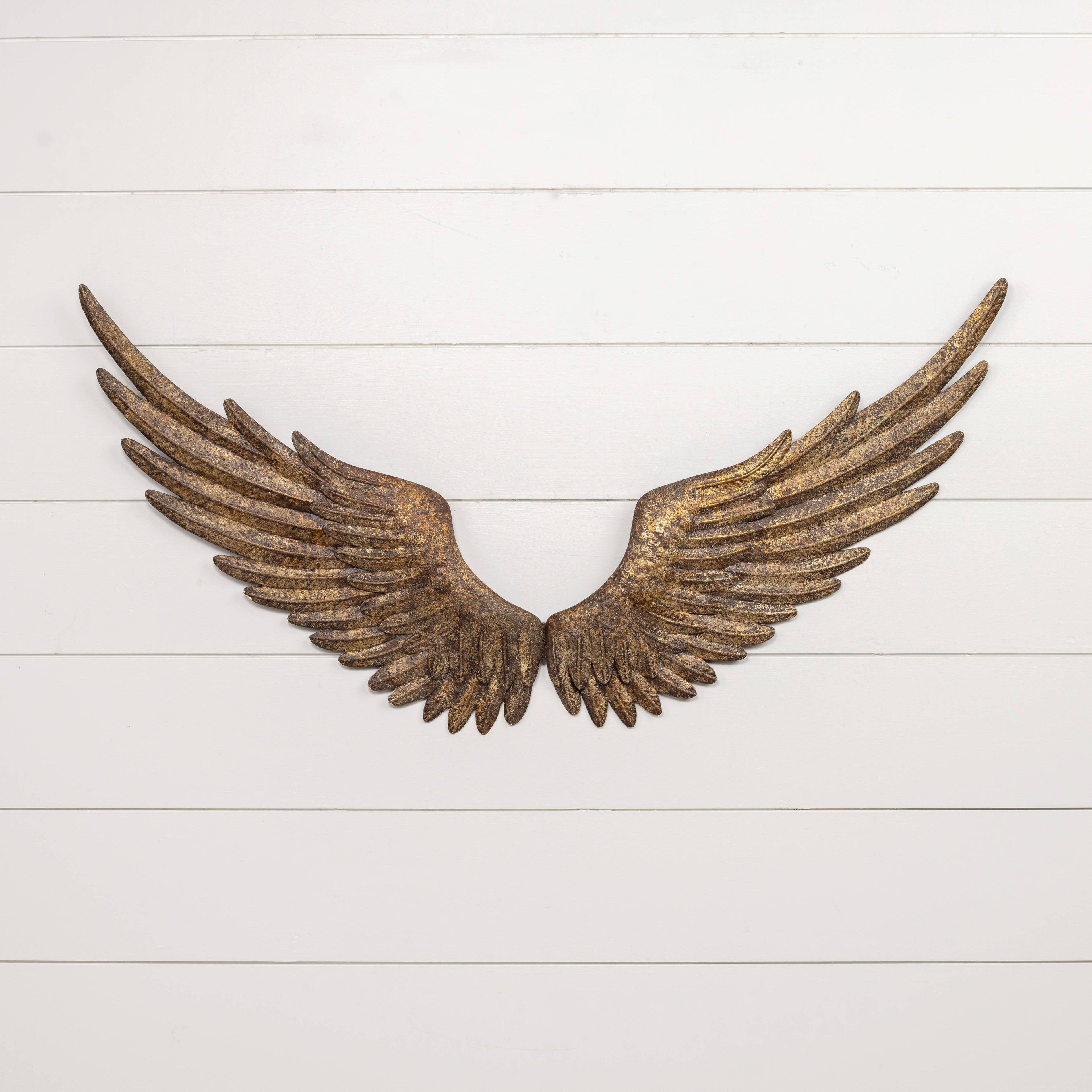 The ANTIQUE REPRODUCTION GOLD WALL WINGS by Ragon House feature a rustic golden-bronze finish and hang symmetrically on a white shiplap wall with sturdy keyhole hangers, creating striking decorative wall art.