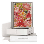 A box of Red Cap Cards’ Wild Florals greeting card: Single, showcasing a vibrant design with red, pink, and orange flowers. The open box displays the illustrated front atop two stacked white Red Cap Cards boxes.