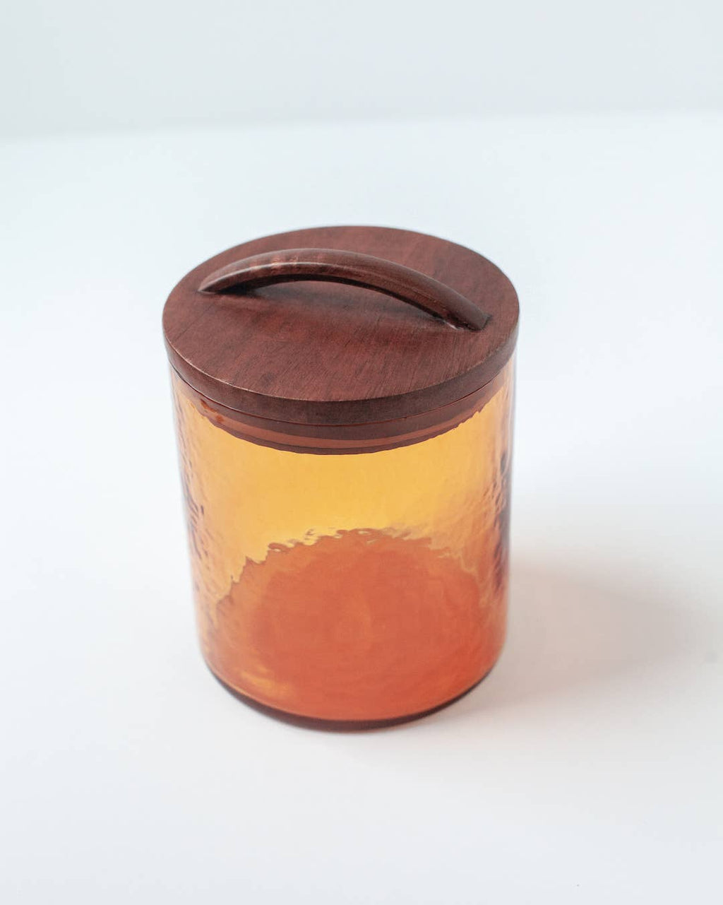 Handblown Hammered Glass Canisters: Smoke / Medium by Creative Women, featuring smoke-colored glass with a hand-carved wooden lid and curved handle, displayed on a white surface.