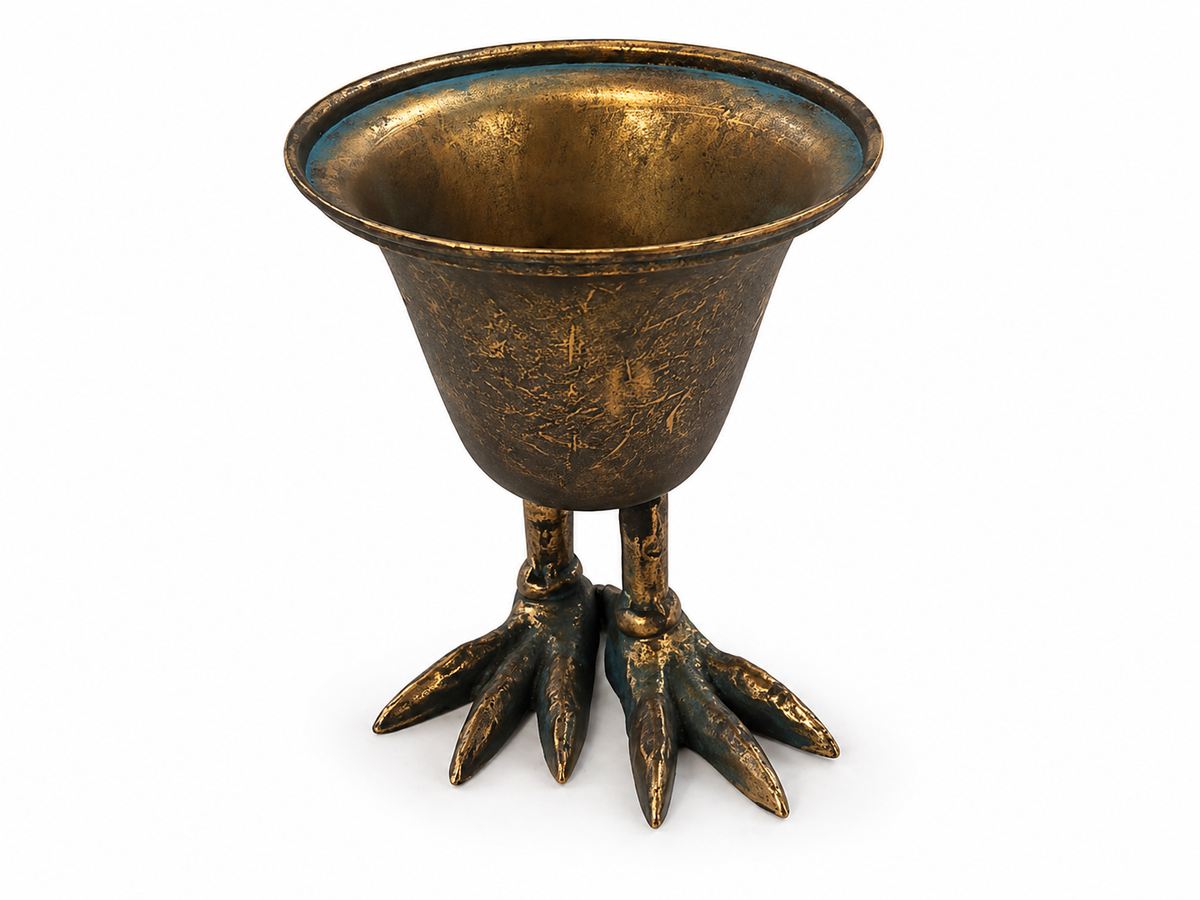 The Metal Bird Claw Pedestal Planter by Vagabond Vintage features a bronze finish, wide rim, and two detailed bird claw feet for a unique, whimsical vintage look.