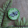 The Iron-on patch | polyphemus moth with lichen - green by ilikesara | art + goods features an embroidered moth on green, white detailing, and is perfect for adding unique insect flair to any garment.